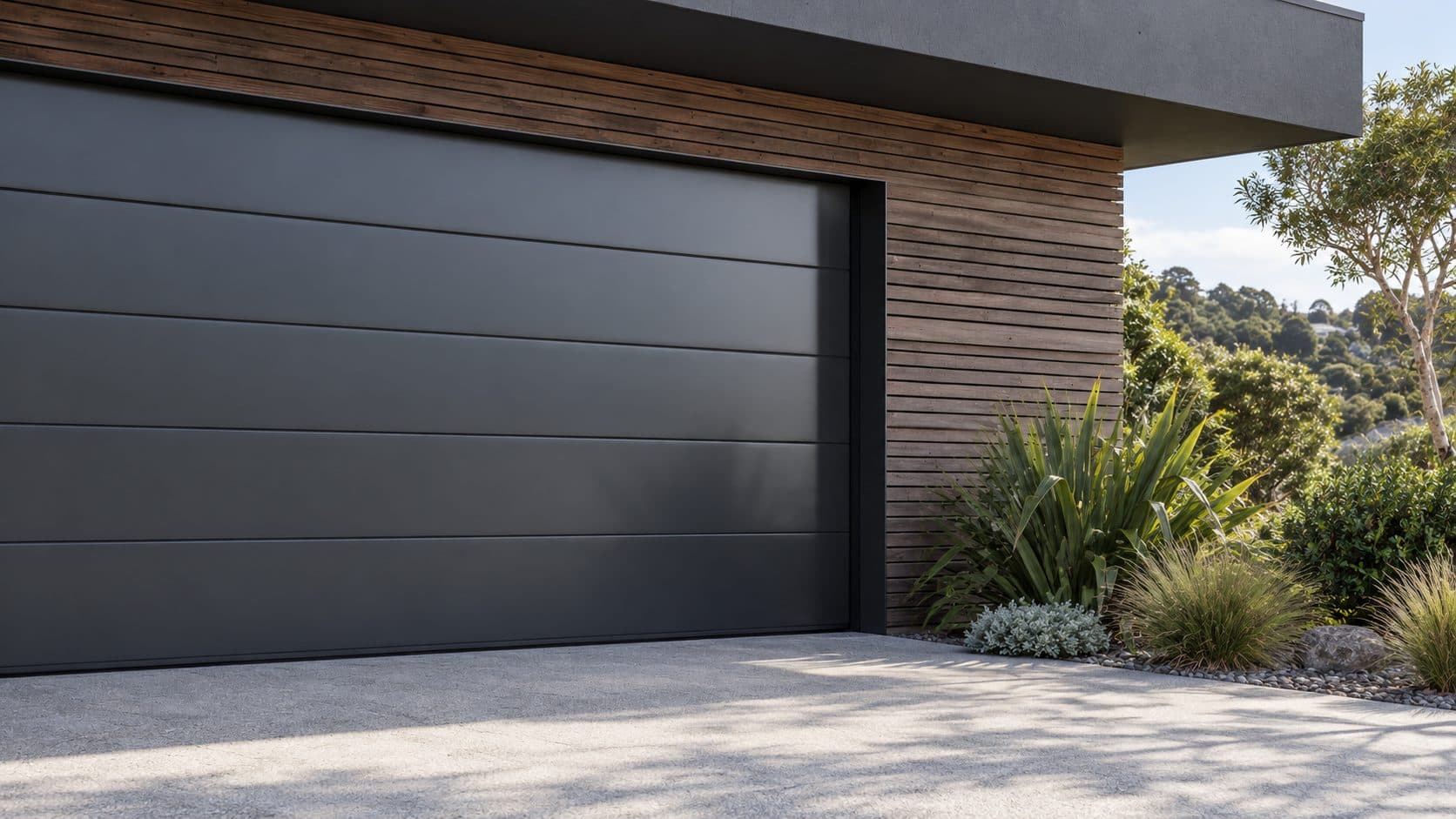 A Smooth Panel 2mm aluminium garage door in a dark powdercoat finish