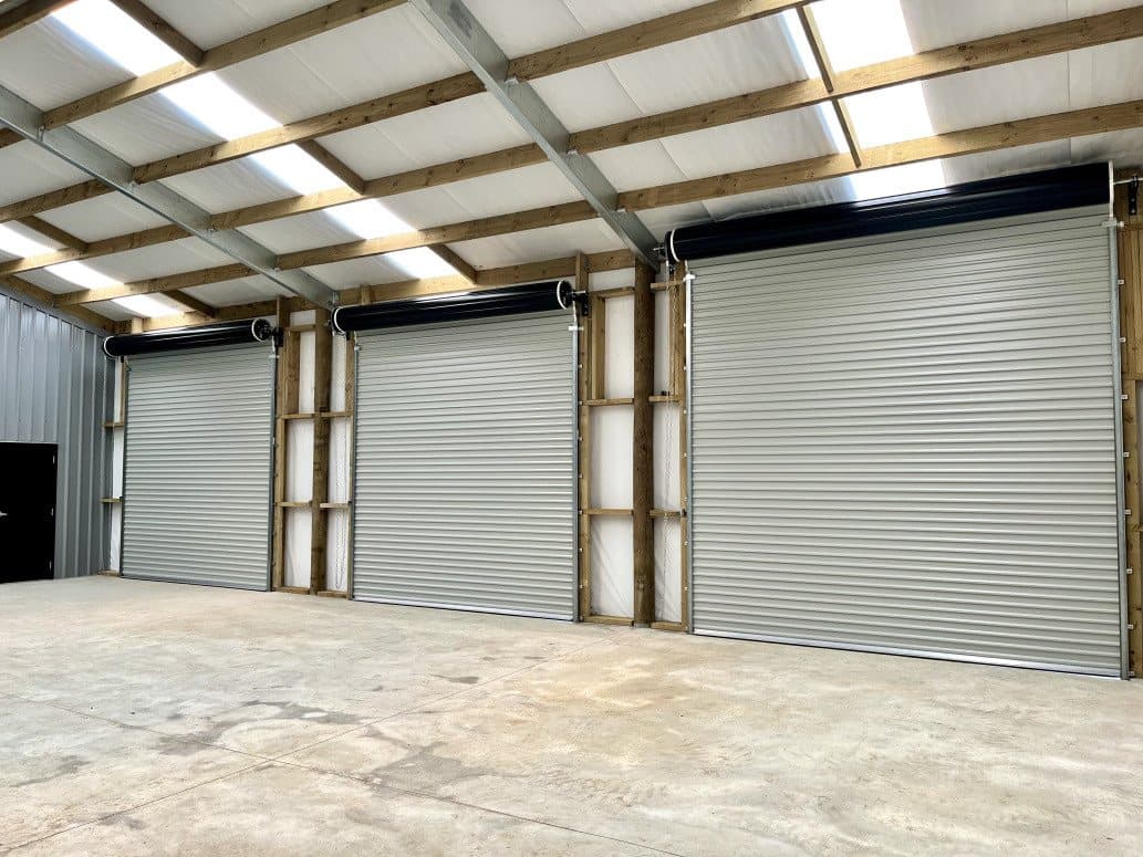 Light commercial roller doors on a steel-clad workshop