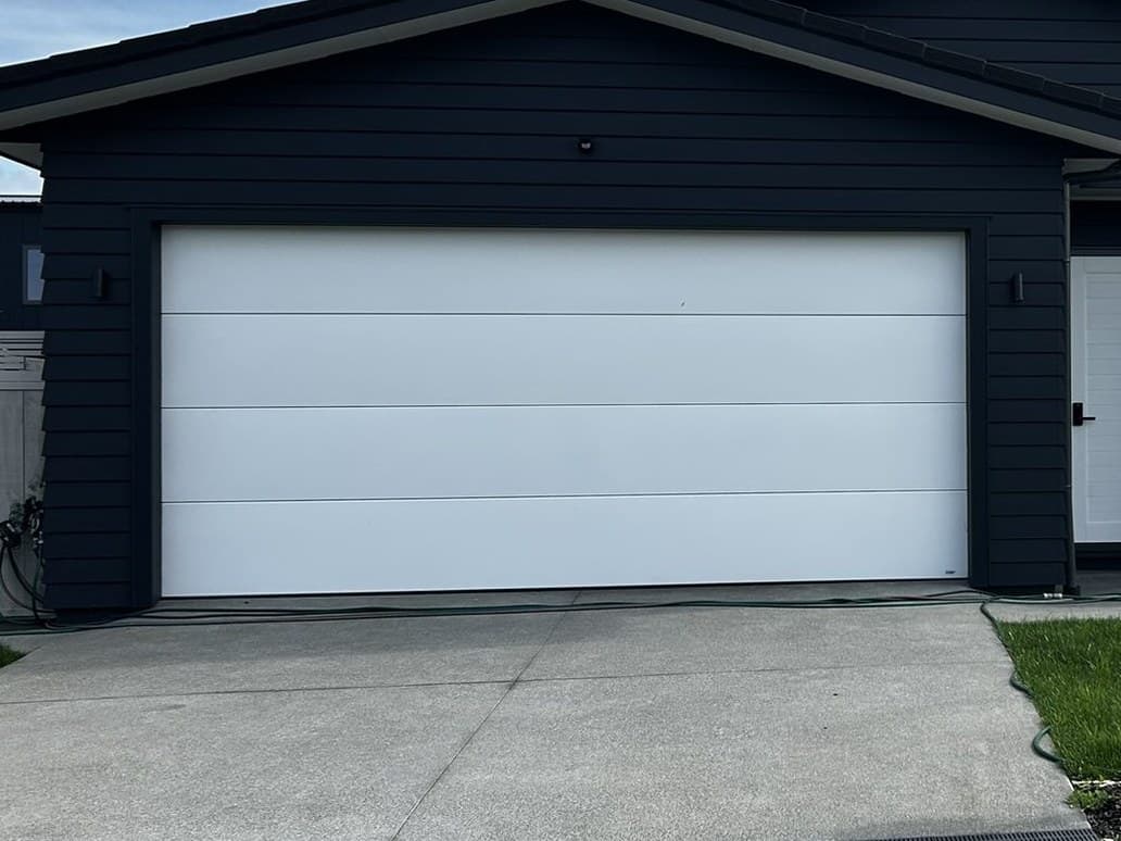 A light sectional garage door on a North Auckland home
