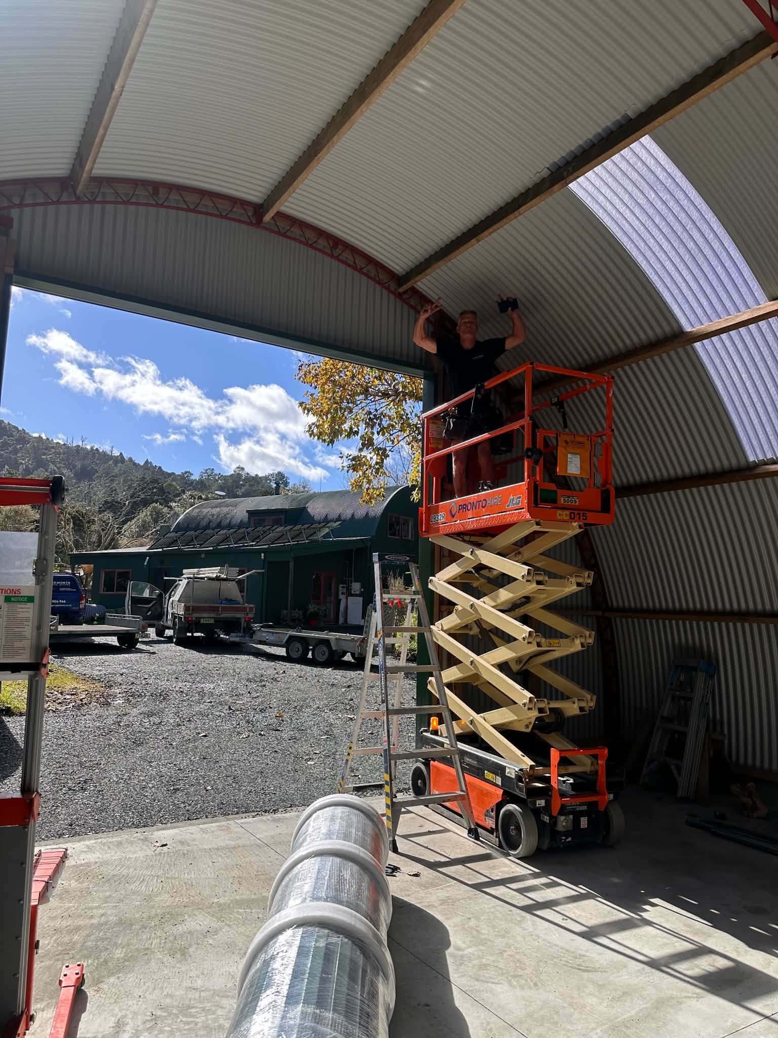 A Garage Door Group technician fitting a door from a scissor lift